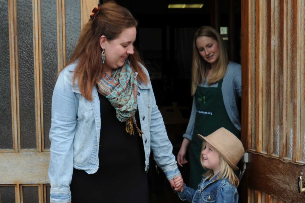 young family at foodbank entrance